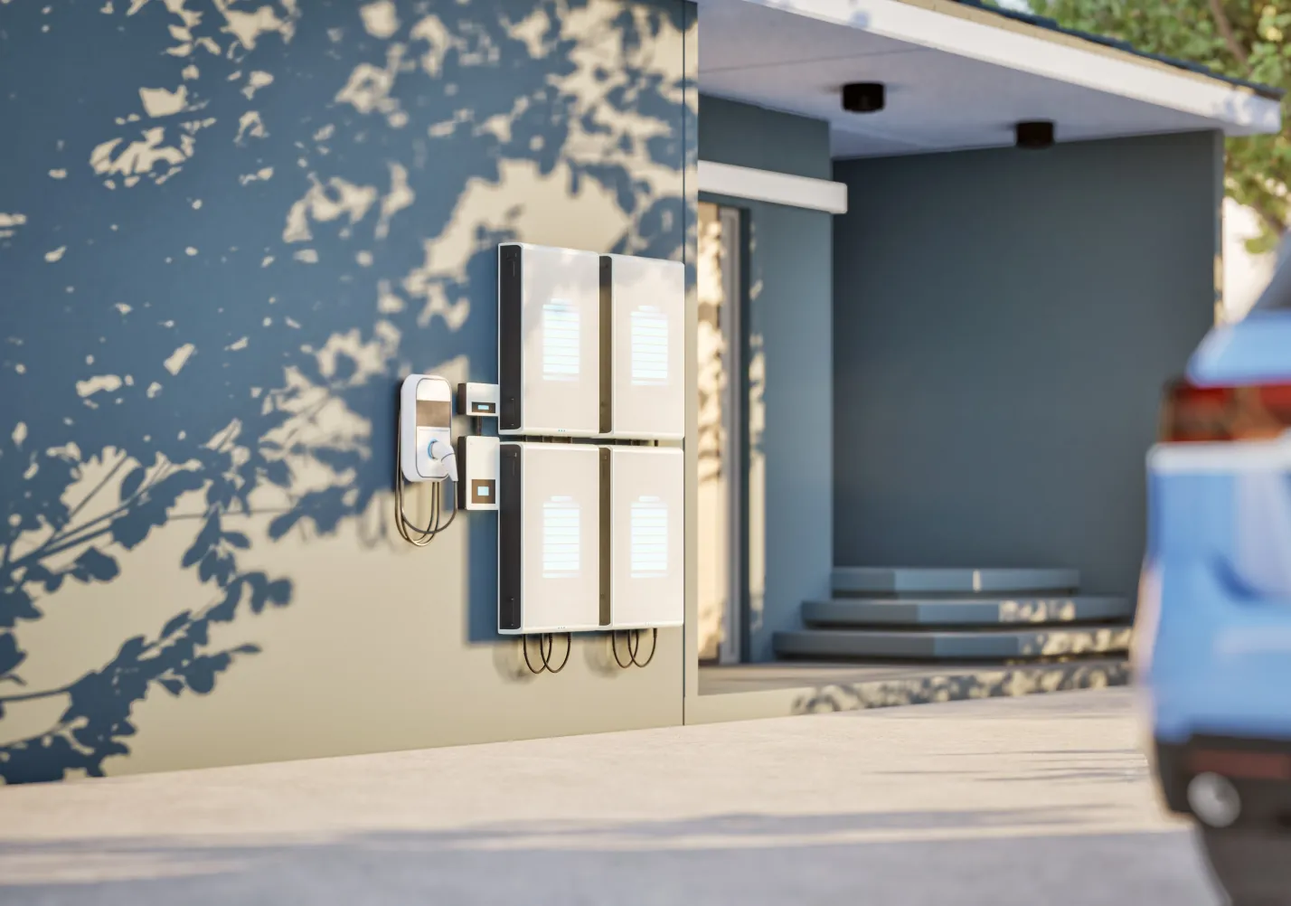 Wall-mounted home battery storage units next to an EV charger outside a house